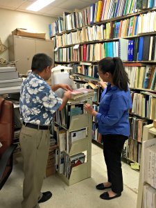 Perry Pangelinan, cataloging librarian and MARC director Monique Carriveau Storie discuss the organization of reference materials in the MARC / Photo by Rianne Peredo